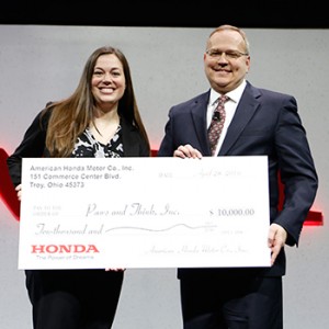 Pictured (from left): Kelsey Burton, Executive Director, Paws & Think; Steve Bailey, Vice President-Parts Operations, American Honda Motor Co.